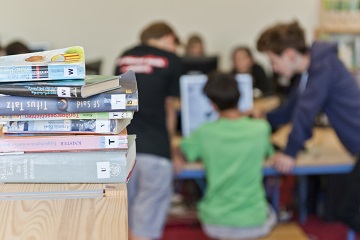 Schüler lernen mit Laptop und Schulbüchern